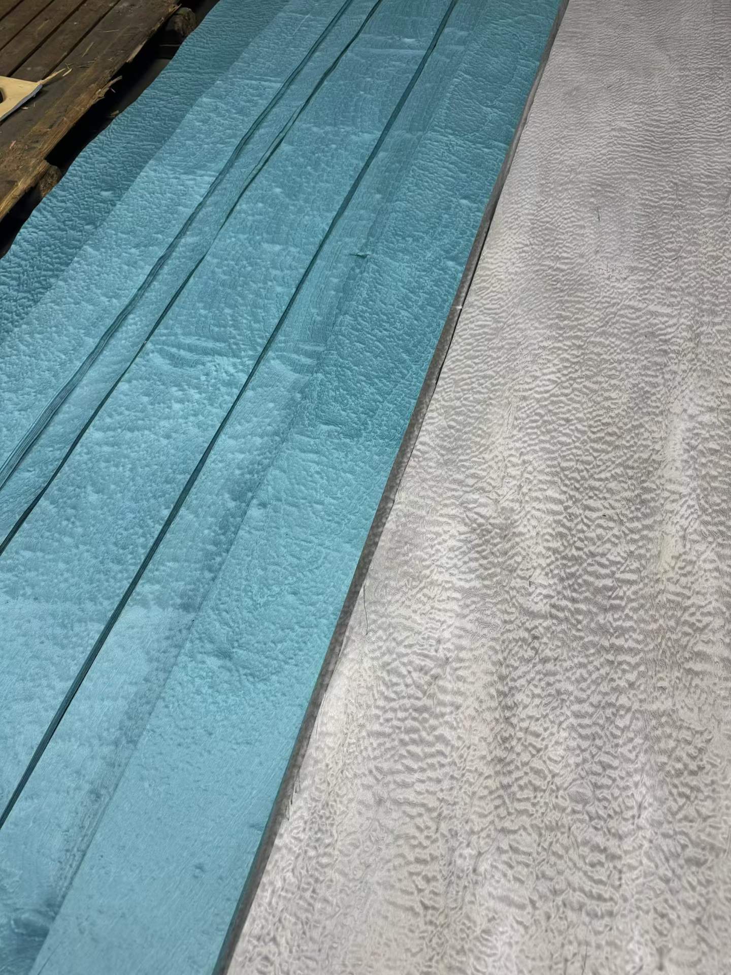 Close-up of blue and grey dyed veneer showing figure
