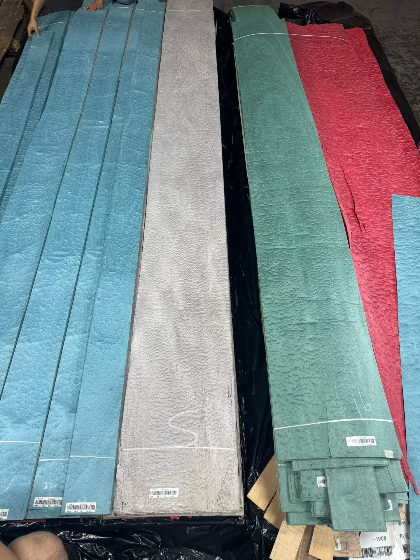 Dyed figured veneer leaves in blue, grey, green and red